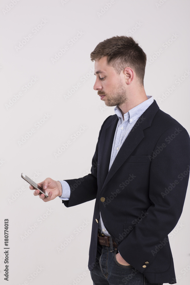Happy man in black suit typing sms on smartphone Happy man in black suit typing sms on smartphone