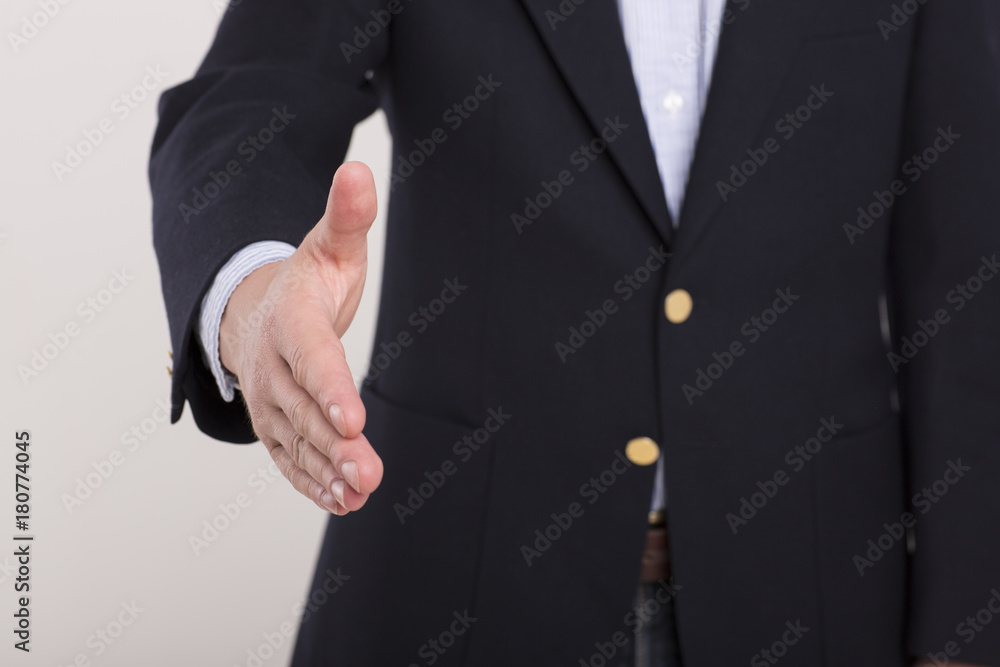 Businessman giving his hand for handshake to partner