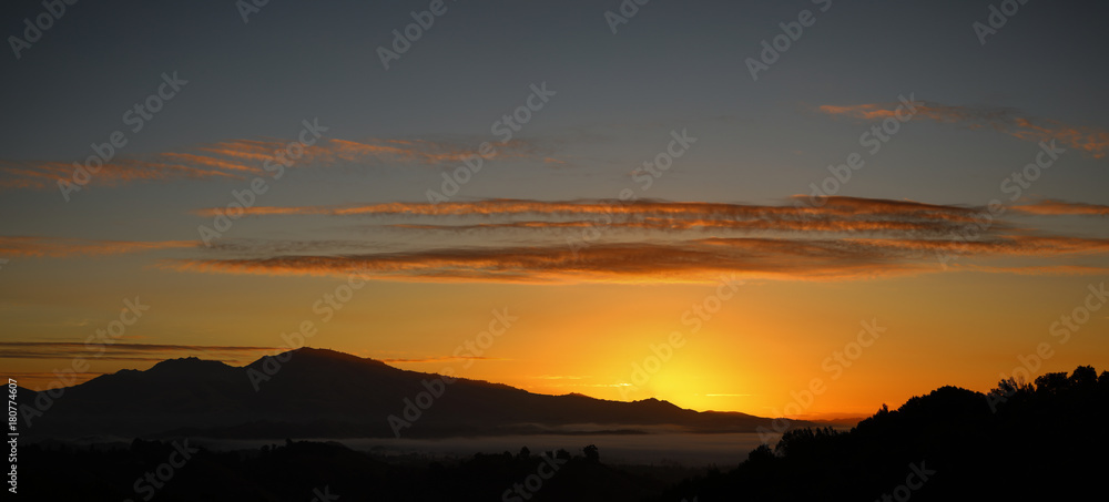 Mount Diablo sunrise panorama over Contra Costa County California showing high clouds and orange sky