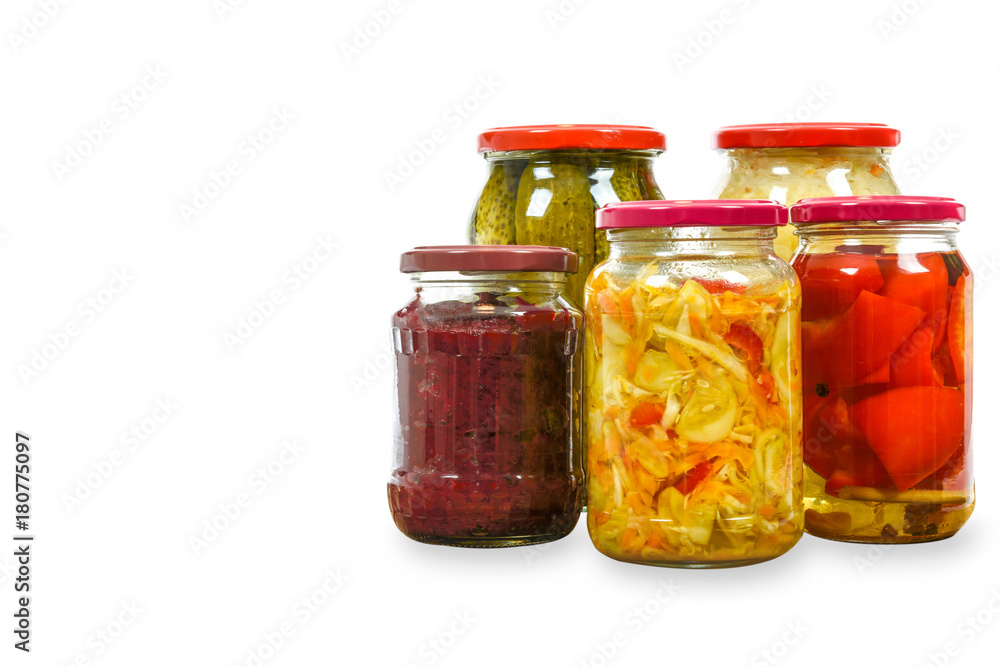 Jars with variety of homemade pickled vegetables isolated on a white background with copy space place . Jars with variety of homemade pickled vegetables isolated on a white background with copy space place .
