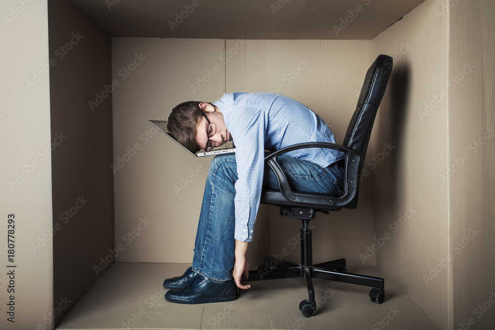 teenager, student in small office working on laptop, in an uncomfortable position, asleep teenager, student in small office working on laptop, in an uncomfortable position, asleep