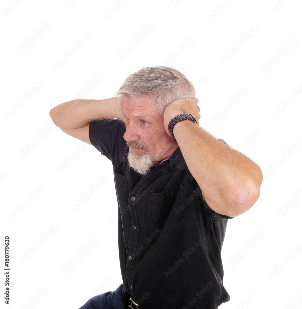 Man holding his hands over his ears Man holding his hands over his ears