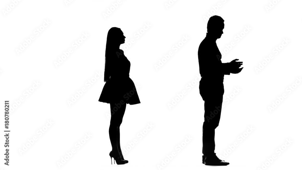 Guy is waiting for the girl, she is late, but comes and kisses him. Silhouette. White background Guy is waiting for the girl, she is late, but comes and kisses him. Silhouette. White background
