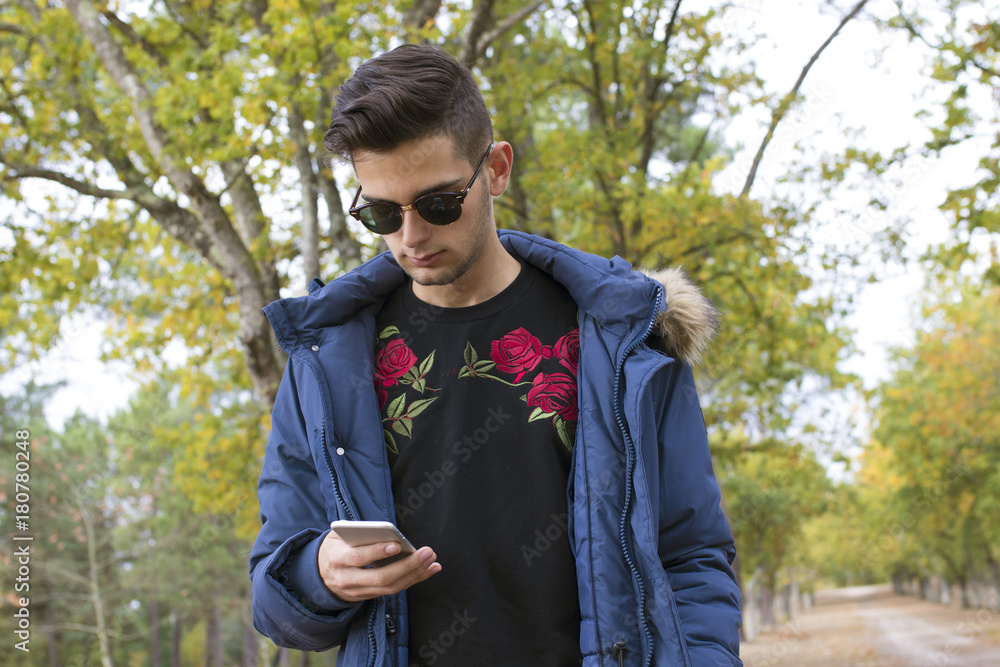 young with mobile phone in the fall outdoors young with mobile phone in the fall outdoors