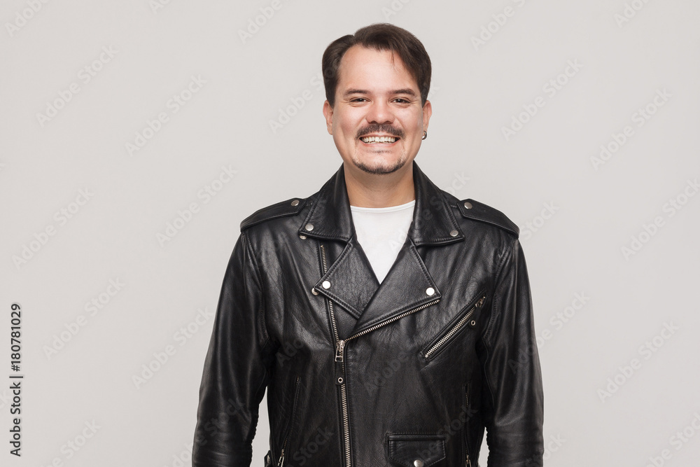 Happiness adult man in leather jacket, looking at camera and toothy smile. Happiness adult man in leather jacket, looking at camera and toothy smile.