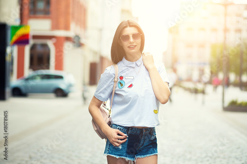 Young brunette woman walking and relaxing in old city street