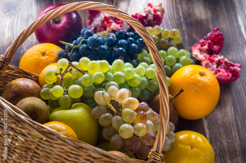 Fototapeta Naklejka Na Ścianę i Meble -  Composition with assorted fruits in wicker basket, healthy life