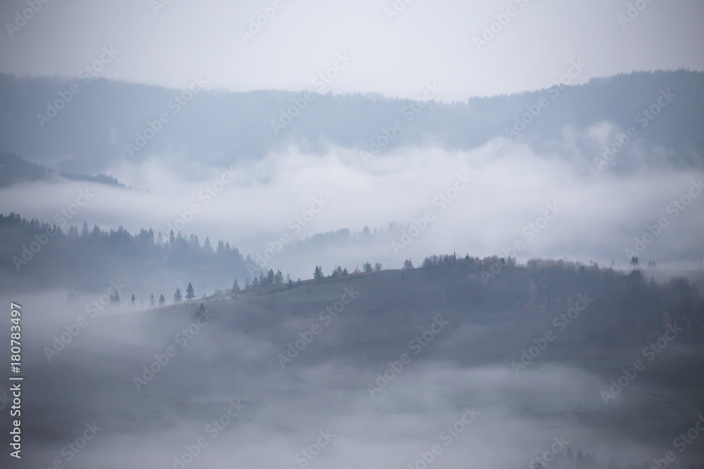 Autumn rain and mist in mountains. Morning fog