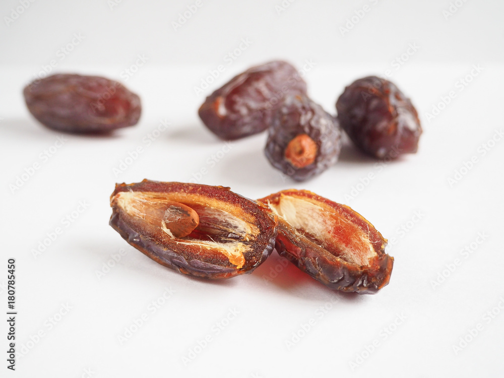 Half dates fruit on white background.
Half dates fruit on white background.