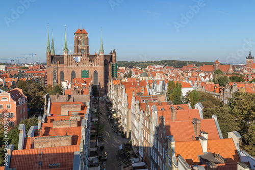 Old residential buildings, Mariacka Street and St. Mary's Church at the Main Town (Old Town) in Gdansk, Poland, viewed from above on a sunny day.