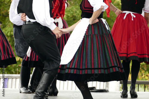 Canvastavla Hungarian folk dancers dancing in black, white and red.