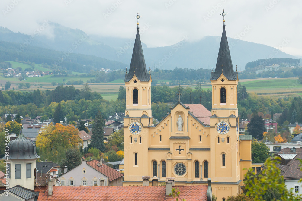 Mesmerising top view on the Parish church in the autumnal city Brunico from the tower of Bruneck castle in Alto Adige, Italy, Europe Mesmerising top view on the Parish church in the autumnal city Brunico from the tower of Bruneck castle in Alto Adige, Italy, Europe