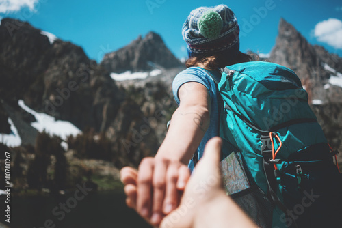 Fotografia, Obraz Young active hiking couple with backpacks taking photo, woman guiding by the han