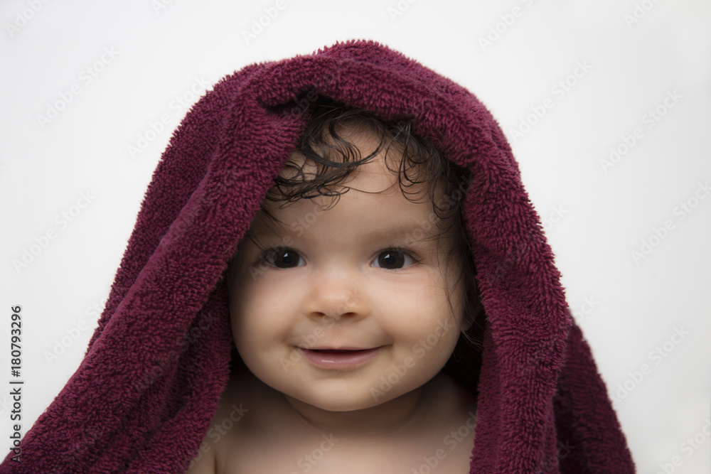 Smiling mixed race baby in red bath towel on white background Smiling mixed race baby in red bath towel on white background
