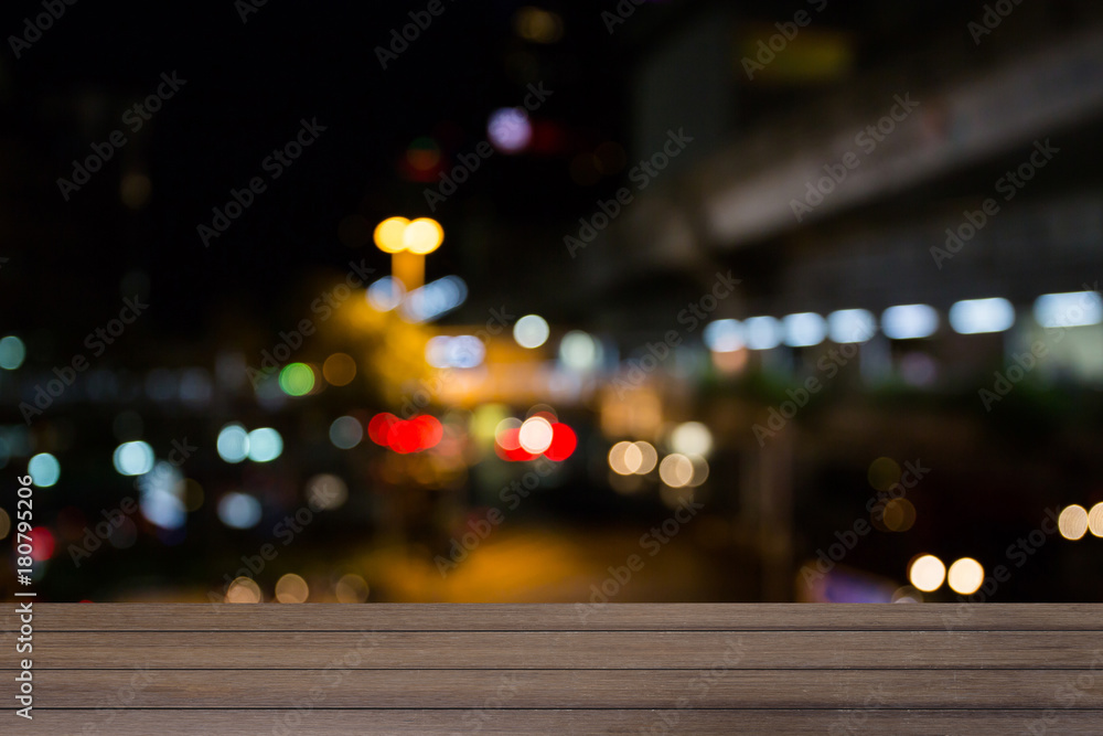 Wood table top on colorful bokeh background at night