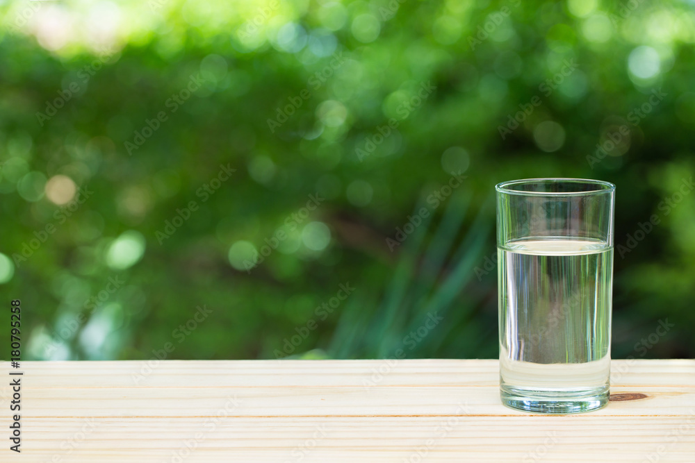 a glass of water on nature background. a glass of water on nature background.