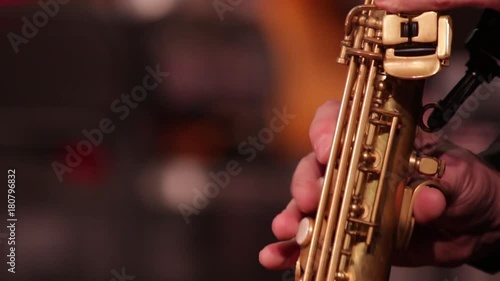 Close-up part of a woodwind instrument soprano saxophone while playing music.