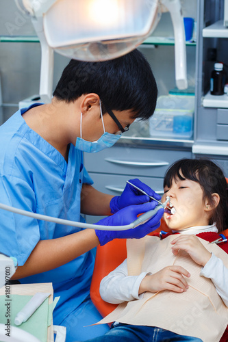 Pediatric dentistry, prevention dentistry, oral hygiene concept. Mechanical way of professional teeth cleaning, painless procedure, dentist at work