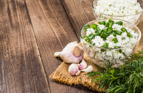 Homemade Herb Curd in bowl (close-up shot) on vintage wooden background