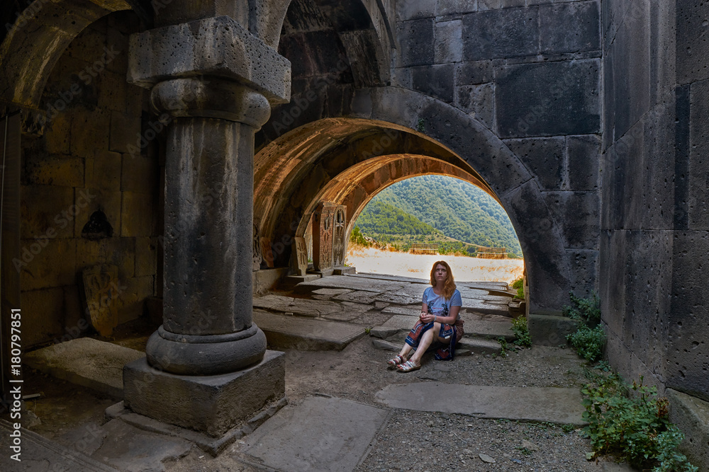 HAGHPAT MONASTERY, ARMENIA - 01 AUGUST 2017: Young Lady enjoying natural light effects in Haghpat Armenian Monastery