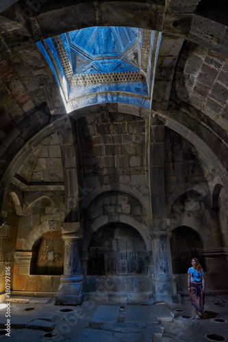 HAGHPAT MONASTERY, ARMENIA - 01 AUGUST 2017: Young Lady enjoying natural light effects in Haghpat Armenian Monastery photo