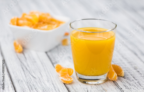 Homemade Tangerine Juice on a wooden table (selective focus)