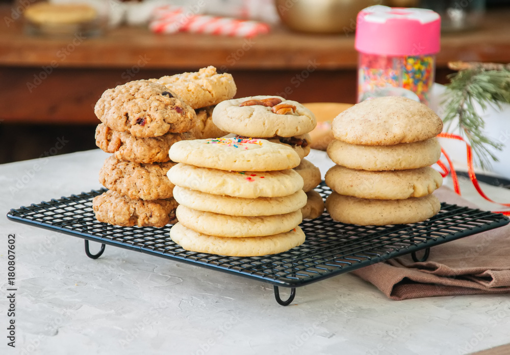 Fotografie Stack of different festive cookies on a wire rack