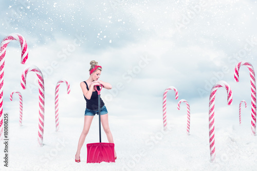 Pin-up girl with snow shovel photo