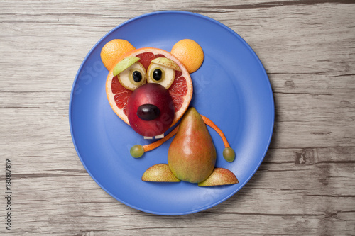 Bear made of fruits on plate and table