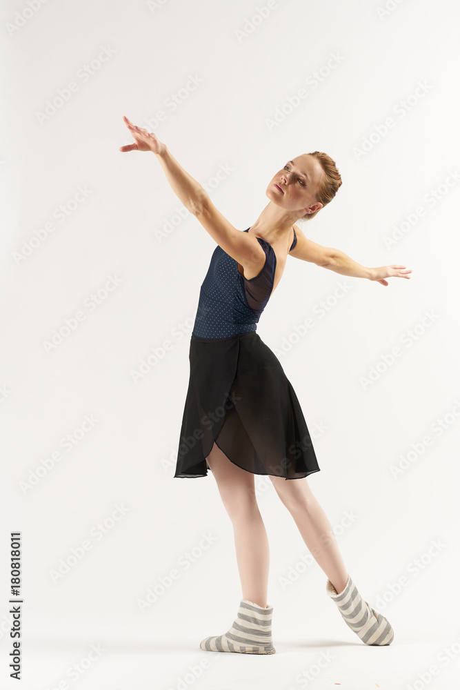 ballerina performs reception on a light background ballerina performs reception on a light background