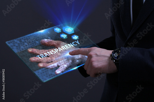 Business, Technology, Internet and network concept. Young businessman working on a virtual screen of the future and sees the inscription: Transparency