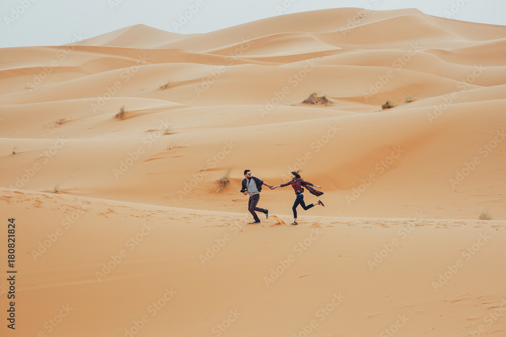 Loving couple in the Sahara Desert. Morocco. Loving couple in the Sahara Desert. Morocco.