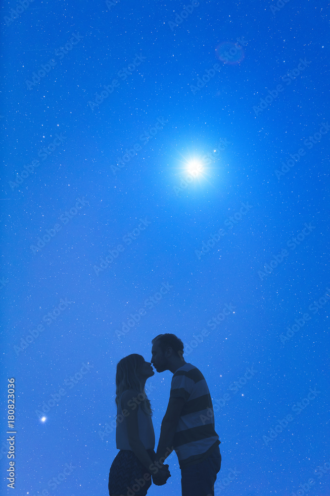 Silhouettes of a young couple under the starry sky. Silhouettes of a young couple under the starry sky.