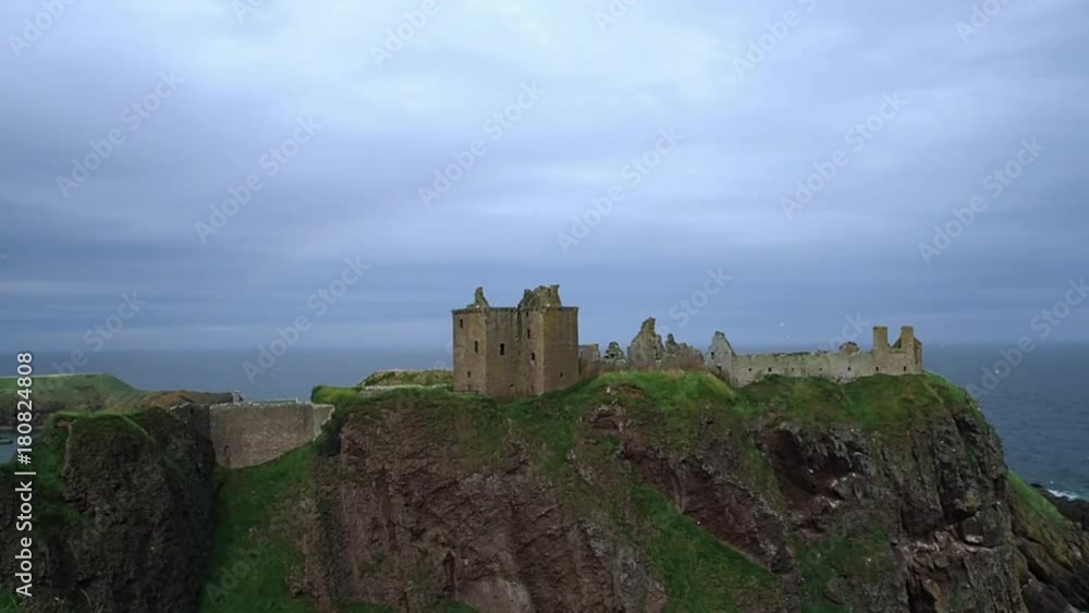 August 2017: the remains of the Dunnottar Castle seen from the nearby hill on a rainy day and wind. August 2017 in Stonehaven August 2017: the remains of the Dunnottar Castle seen from the nearby hill on a rainy day and wind. August 2017 in Stonehaven