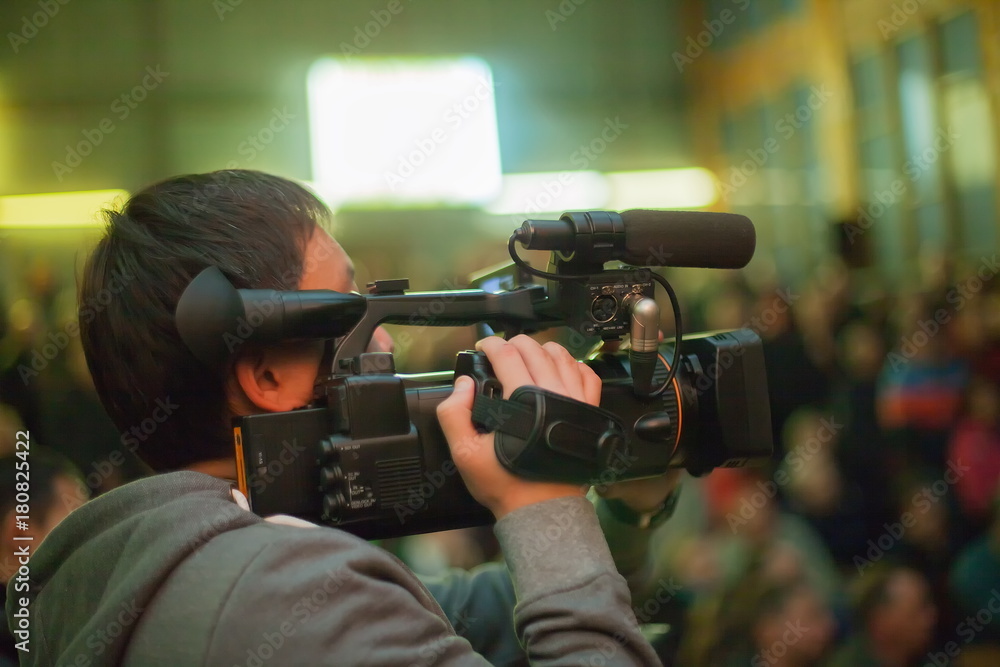 videographer takes a crowd of people in the hall. videographer takes a crowd of people in the hall.