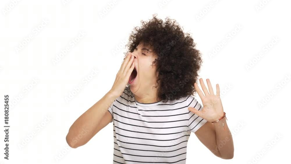 close up portrait of mixed-race lady being sleepy yawning and stretching covering open mouth with hand over white background in studio. Concept of emotions close up portrait of mixed-race lady being sleepy yawning and stretching covering open mouth with hand over white background in studio. Concept of emotions