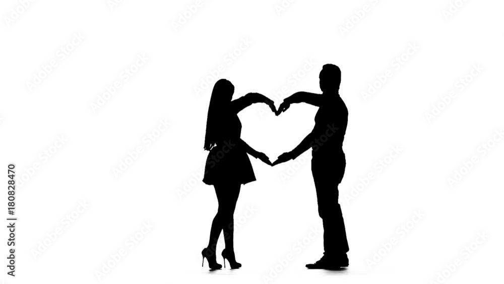 Loving couple makes a heart shape with the help of hands. Silhouette. White background. Slow motion Loving couple makes a heart shape with the help of hands. Silhouette. White background. Slow motion
