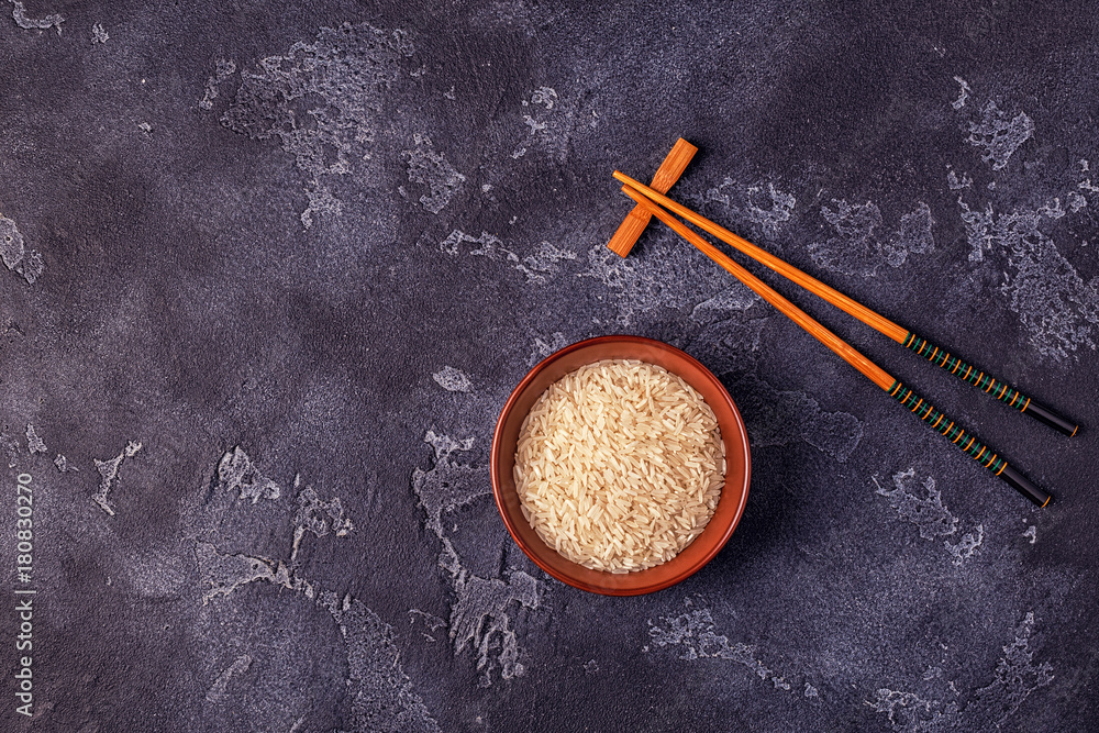 Rice in a bowl and wooden chopsticks. Rice in a bowl and wooden chopsticks.