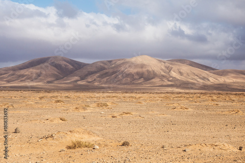 Dry out desert in Fuerteventura with mountains behind 