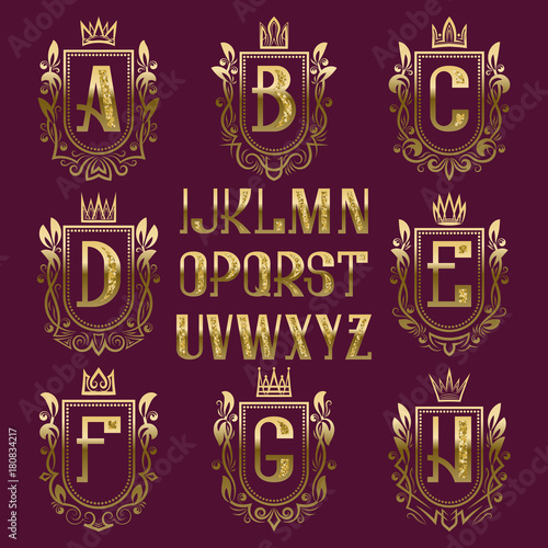 Patterned medieval coat of arms kit. Golden letters and ornamental wreath frames for creating initial logo in vintage style.