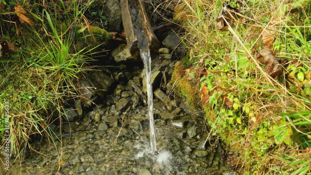 mountain spring. view from above on a wooden chute mountain spring. view from above on a wooden chute