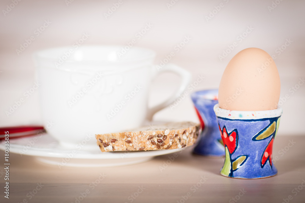 Dieting - Breakfast with boiled egg in an eggcup and whole-wheat bread Dieting - Breakfast with boiled egg in an eggcup and whole-wheat bread