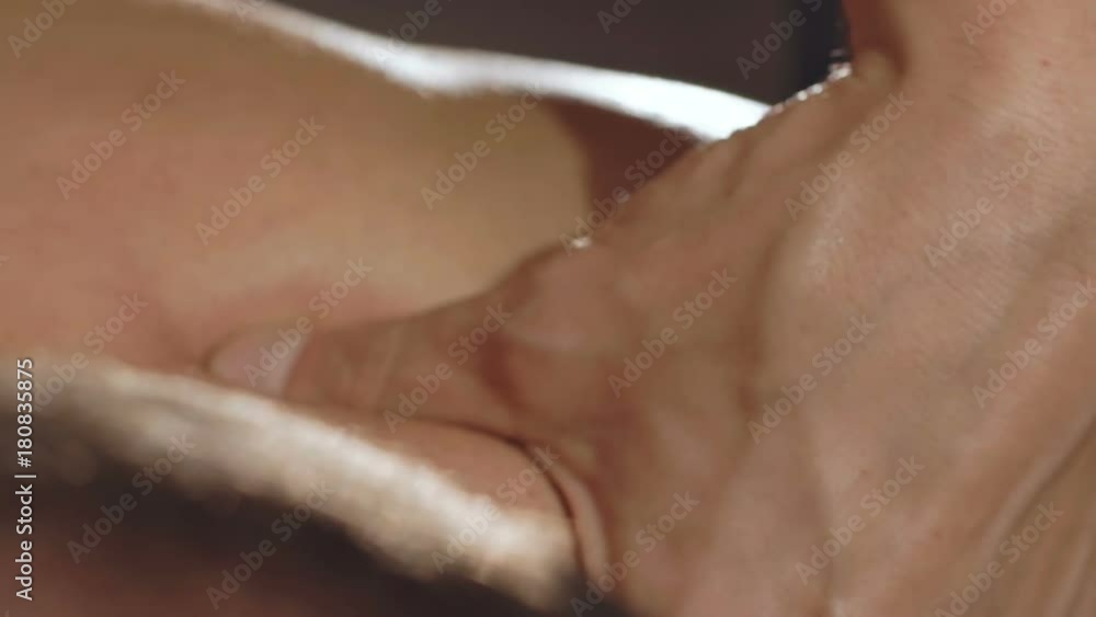 Macro shoot of masseur's hand makes a neck massage Macro shoot of masseur's hand makes a neck massage