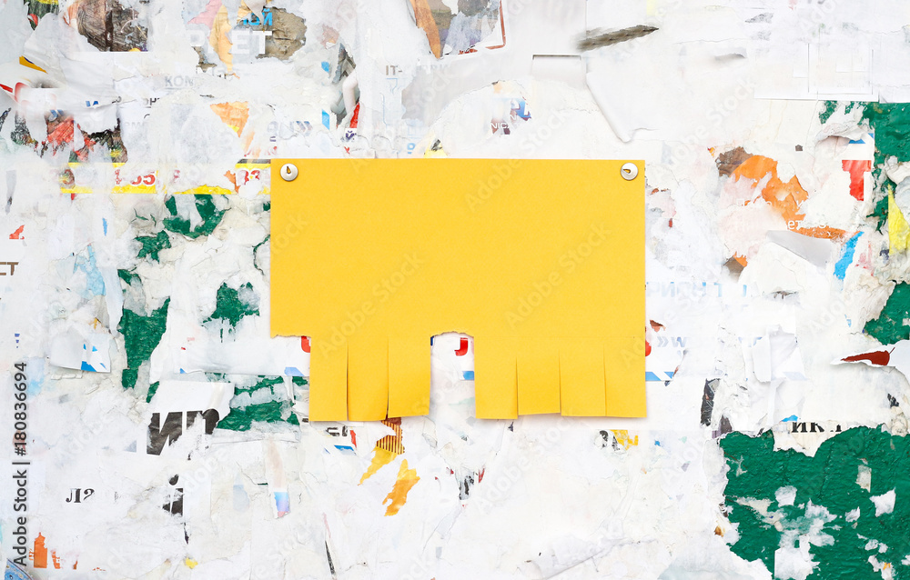 Fototapeta premium Empty colorful paper ad inserts on a dirty Board. Fastens with metal buttons. Blank ad with cut slips
