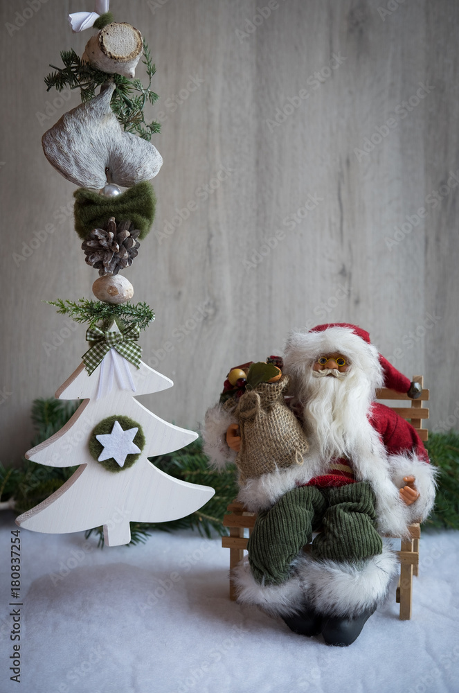Fototapeta premium Christmas ornaments with snow, pine tree and Santa Claus