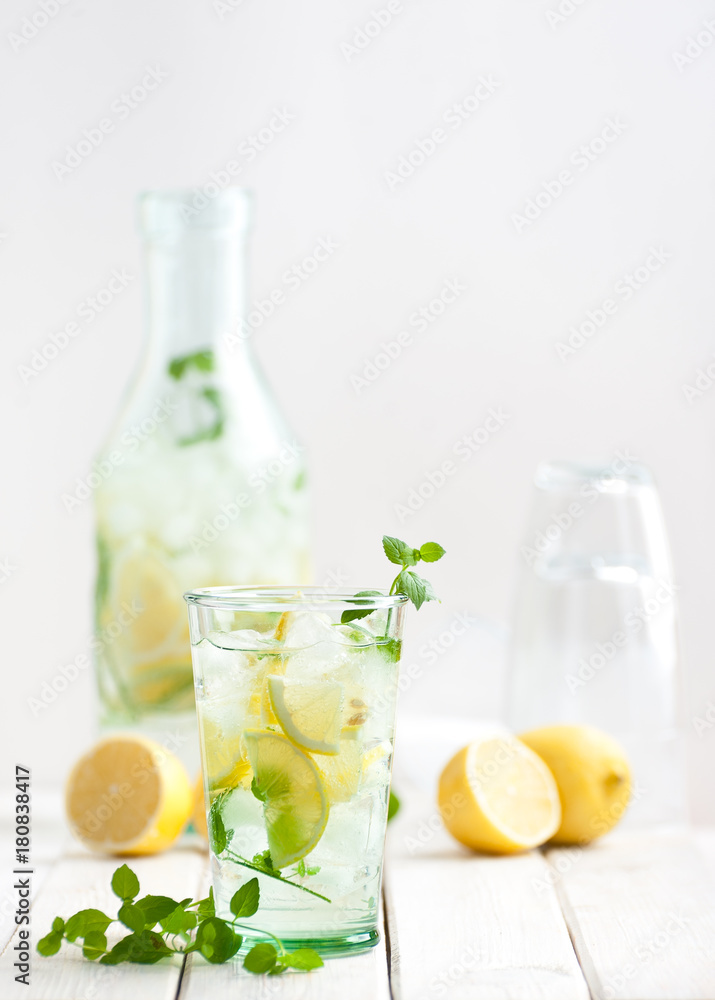 Lemonade lemonade in a glass cup on a white wooden table.. Lemonade lemonade in a glass cup on a white wooden table..