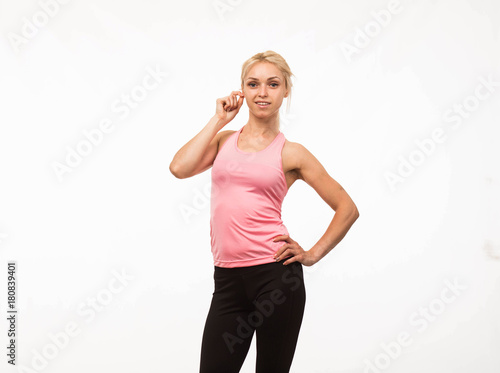 Young cheerful woman portrait of a confident businesswoman showing by hands on a gray background. Ideal for banners, registration forms, presentation, landings, presenting concept