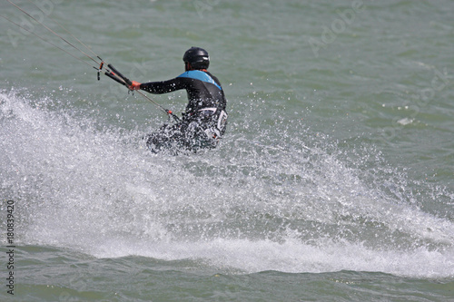 kitesurfer riding his board