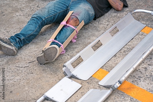 A Man broke his leg in an accident.
splint medical equipment using to transport stretcher.