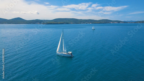 Aerial view of yacht sailing near beautiful Islands. Beautiful clouds in the background. Luxury yacht in the sea. © aerocaminua